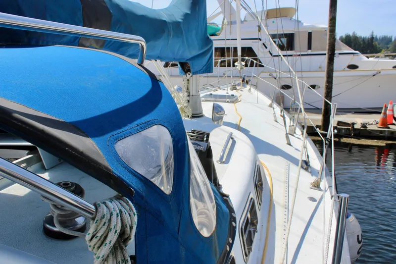 Slide: The Image of Sailboat Freya 39, 1993 model, docked at marina with blue canopy. - 3