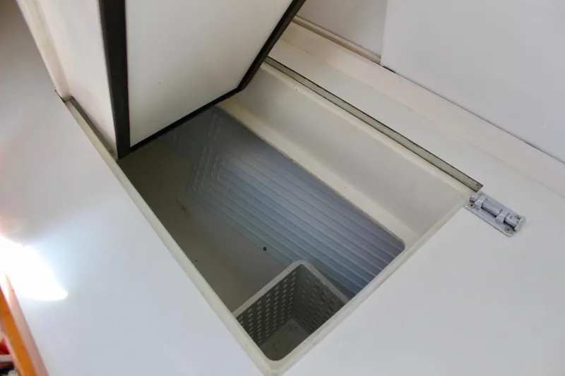 Slide: The Image of Open storage compartment on Freya 39 yacht, 1993 model, with white interior and basket. - 32