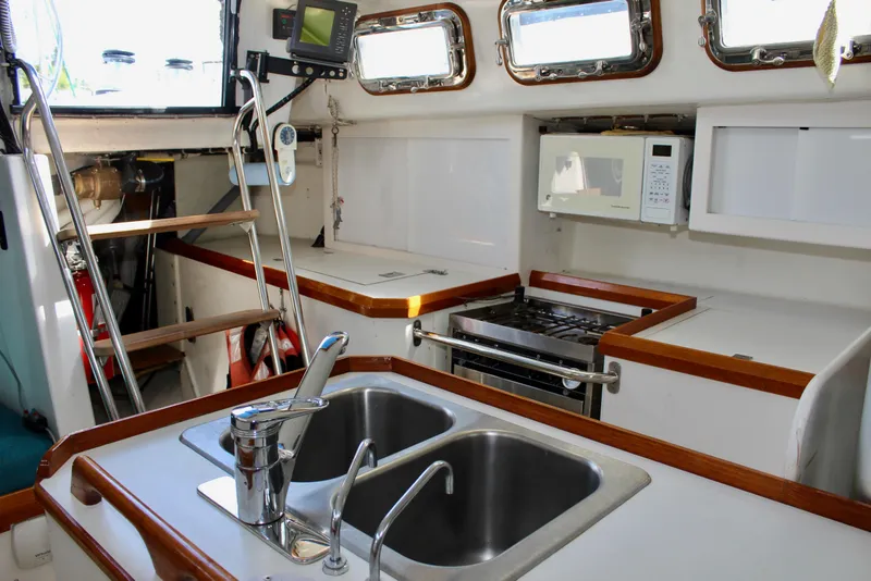 Slide: The Image of Interior of 1993 Freya 39 yacht kitchen with sink, stove, and microwave. - 33