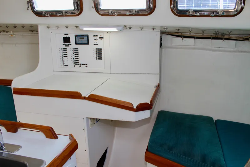 Slide: The Image of Interior of 1993 Freya 39 sailboat with control panel and teal seating. - 38