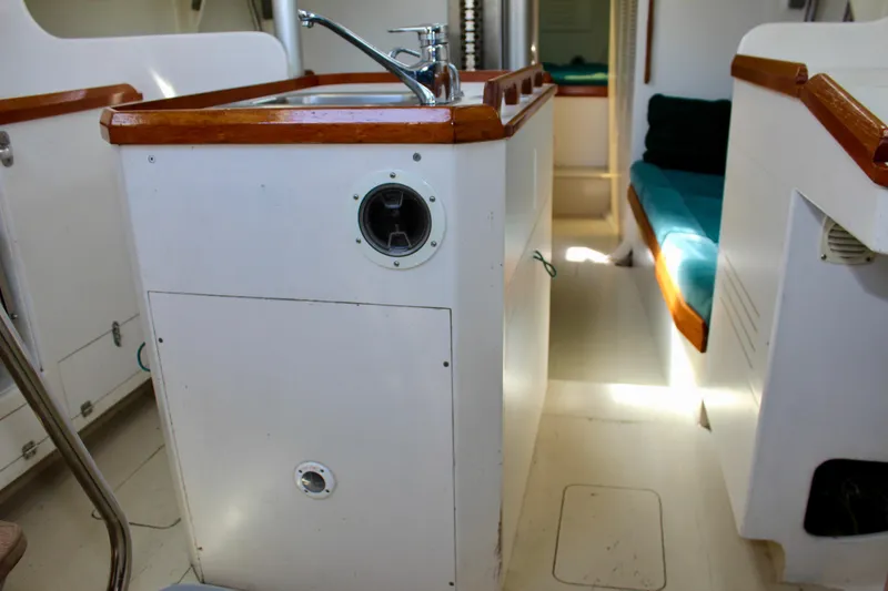 Slide: The Image of Interior of a 1993 Freya 39 sailboat featuring a compact kitchen area. - 41