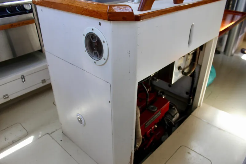 Slide: The Image of Engine compartment of a 1993 Freya 39 sailboat, featuring a visible red engine. - 42