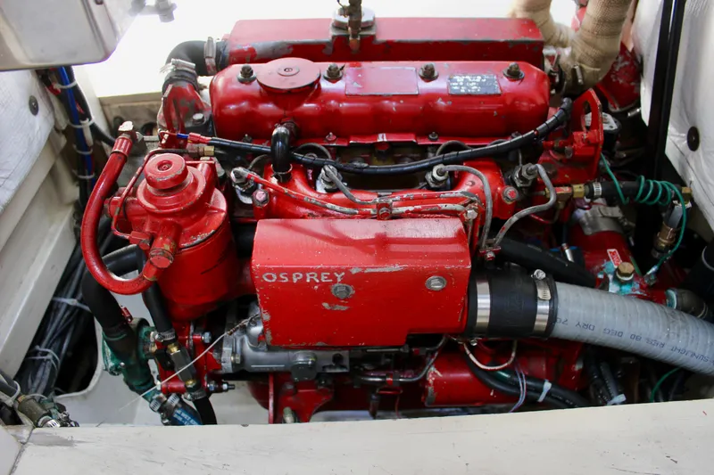 Slide: The Image of Red engine of a 1993 Freya 39 boat, labeled "Osprey," with visible hoses and components. - 44