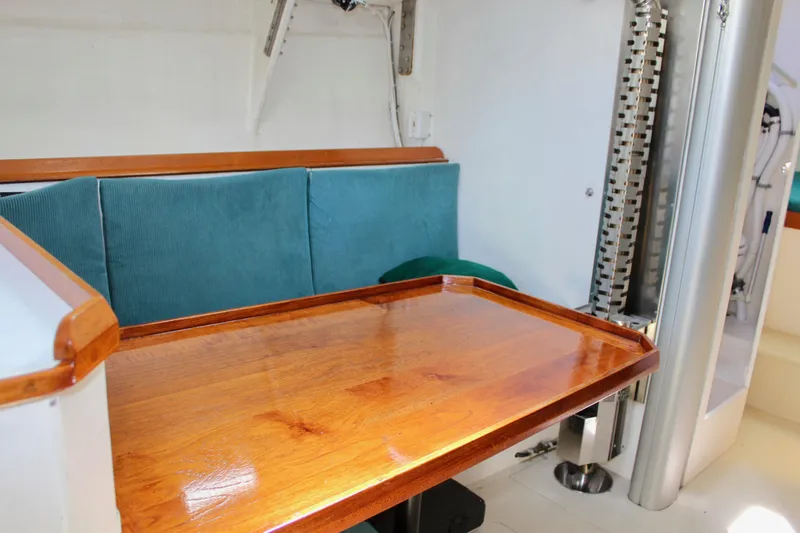 Slide: The Image of Interior of 1993 Freya 39 yacht with wooden table and teal seating. - 48
