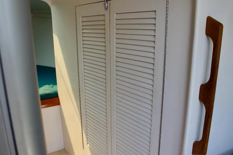 Slide: The Image of Interior of 1993 Freya 39 sailboat with louvered closet doors and wooden handle. - 52