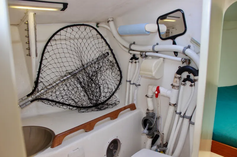 Slide: The Image of Interior of 1993 Freya 39 boat showing plumbing, net, and sink. - 53