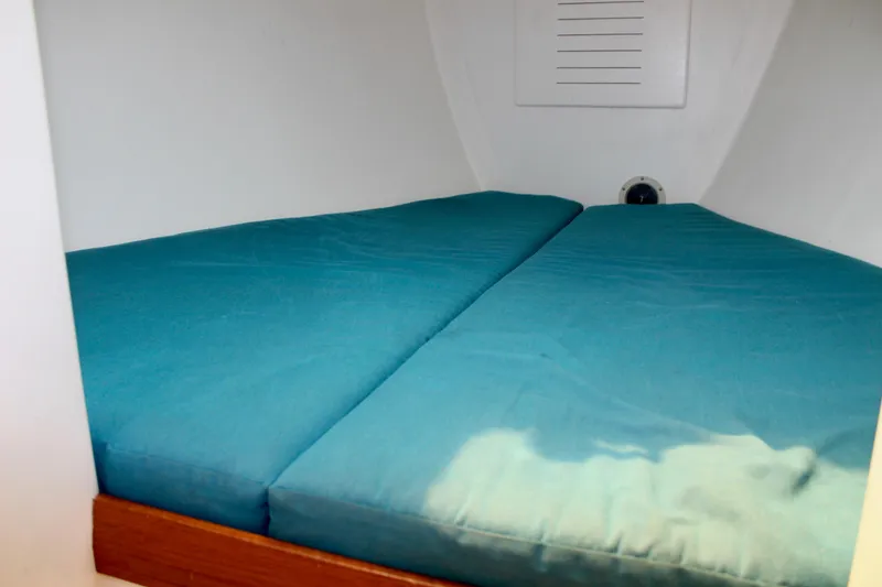 Slide: The Image of Cozy cabin bed with teal cushions in a 1993 Freya 39 sailboat. - 58