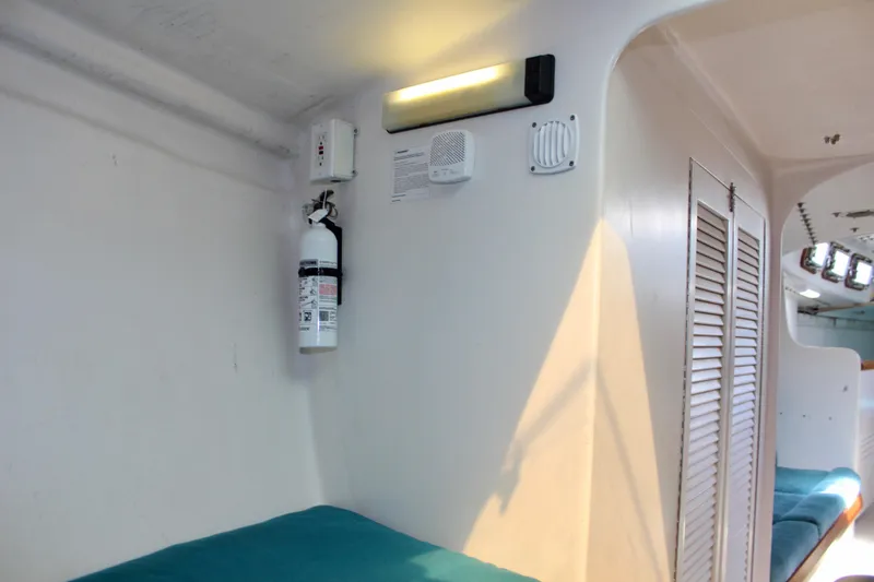 Slide: The Image of Interior of 1993 Freya 39 yacht with fire extinguisher and teal seating. - 60