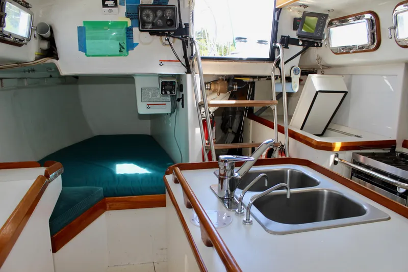 Slide: The Image of Interior of a 1993 Freya 39 sailboat featuring a compact kitchen and sleeping area. - 62