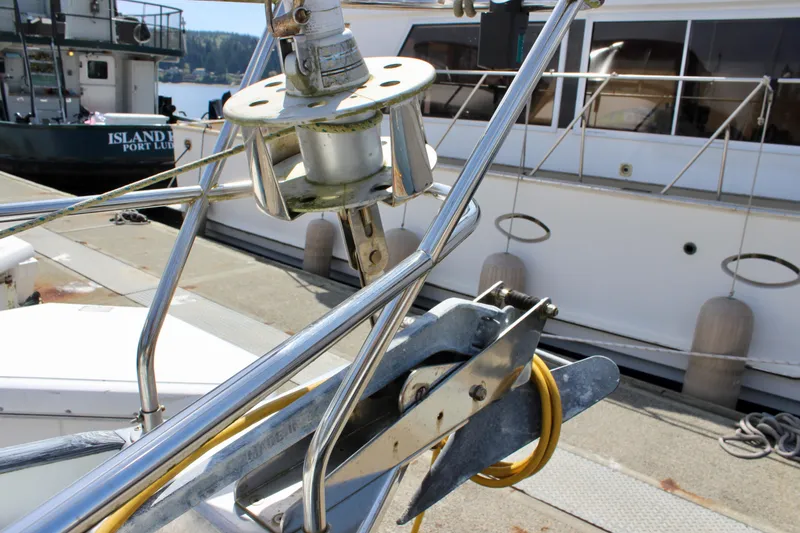 Slide: The Image of Bow of 1993 Freya 39 sailboat with anchor and docked boats in background. - 8