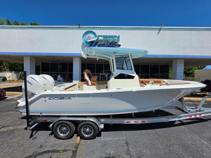The Image of 2026 Cobia 245CC boat on trailer outside Ocean Marine. - 1