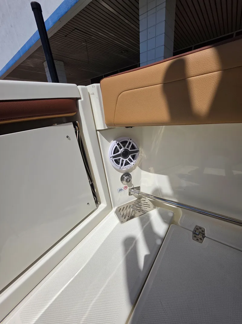 Slide: The Image of Interior of a 2026 Cobia 245CC boat with speaker. - 11