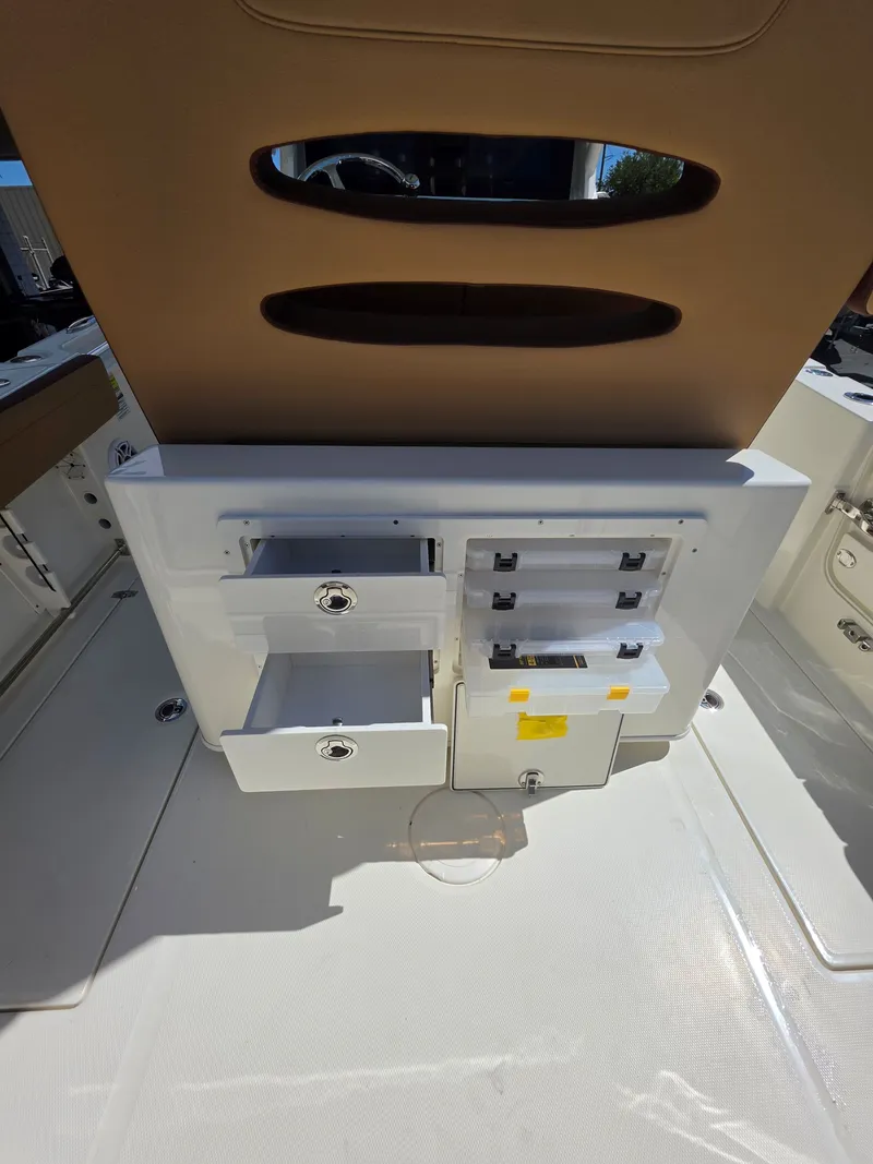 Slide: The Image of Cobia 245CC 2026 boat featuring storage compartments and drawers. - 12