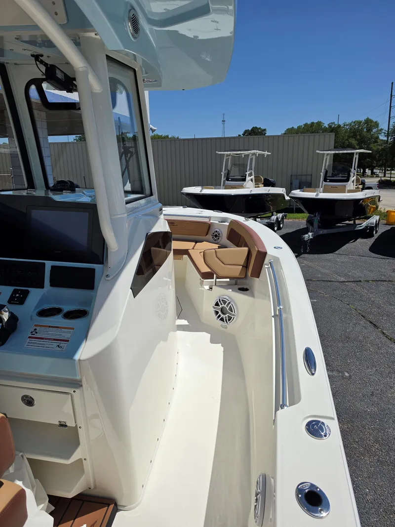 Slide: The Image of 2026 Cobia 245CC boat with modern features and comfortable seating. - 14