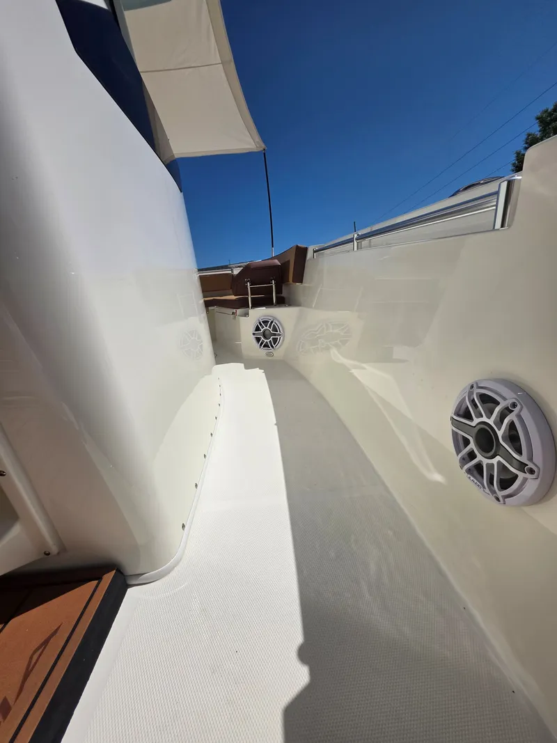 Slide: The Image of Cobia 245CC 2026 boat, side view with speakers, blue sky. - 15