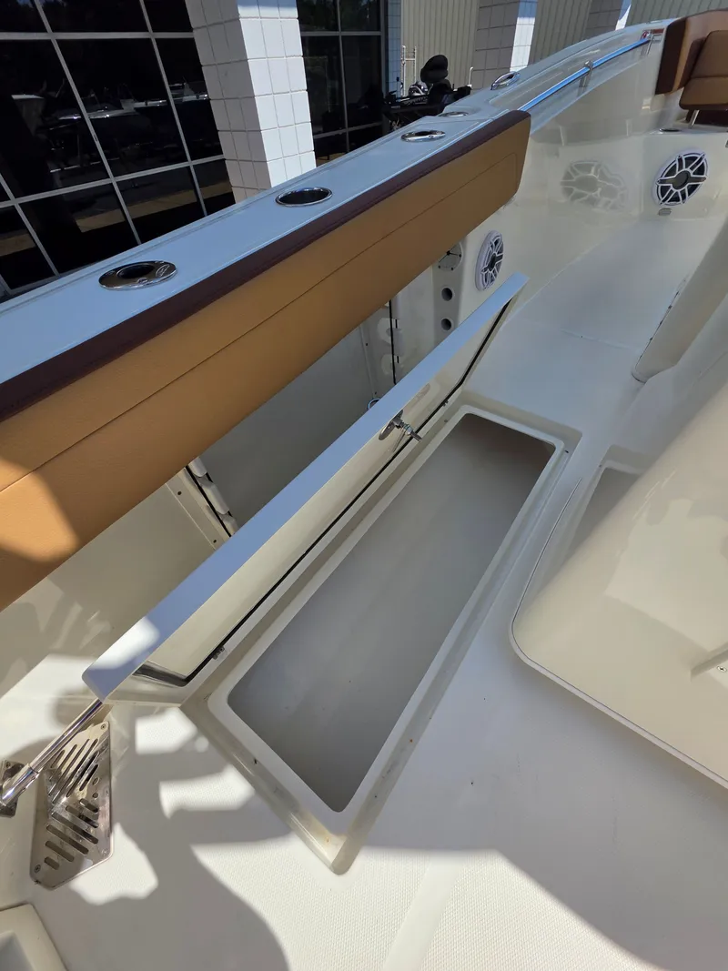 Slide: The Image of Interior view of 2026 Cobia 245CC boat with storage compartment. - 16
