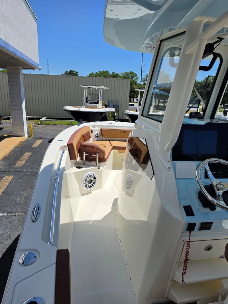 Slide: The Image of 2026 Cobia 245CC boat with modern features and helm console. - 17