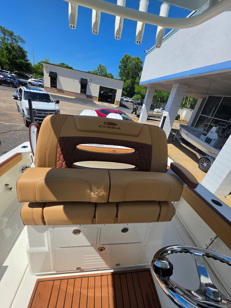 Slide: The Image of Cobia 245CC 2026 boat seat with brown leather upholstery. - 20