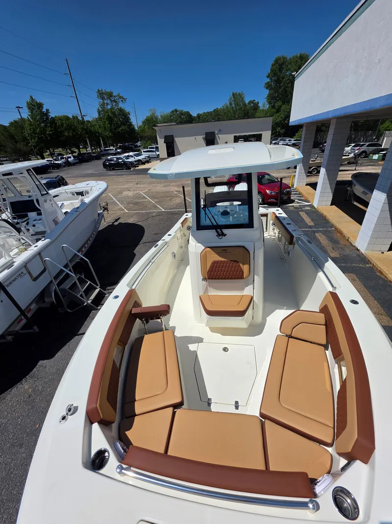 Slide: The Image of 2026 Cobia 245CC boat with brown seating and sunshade. - 22