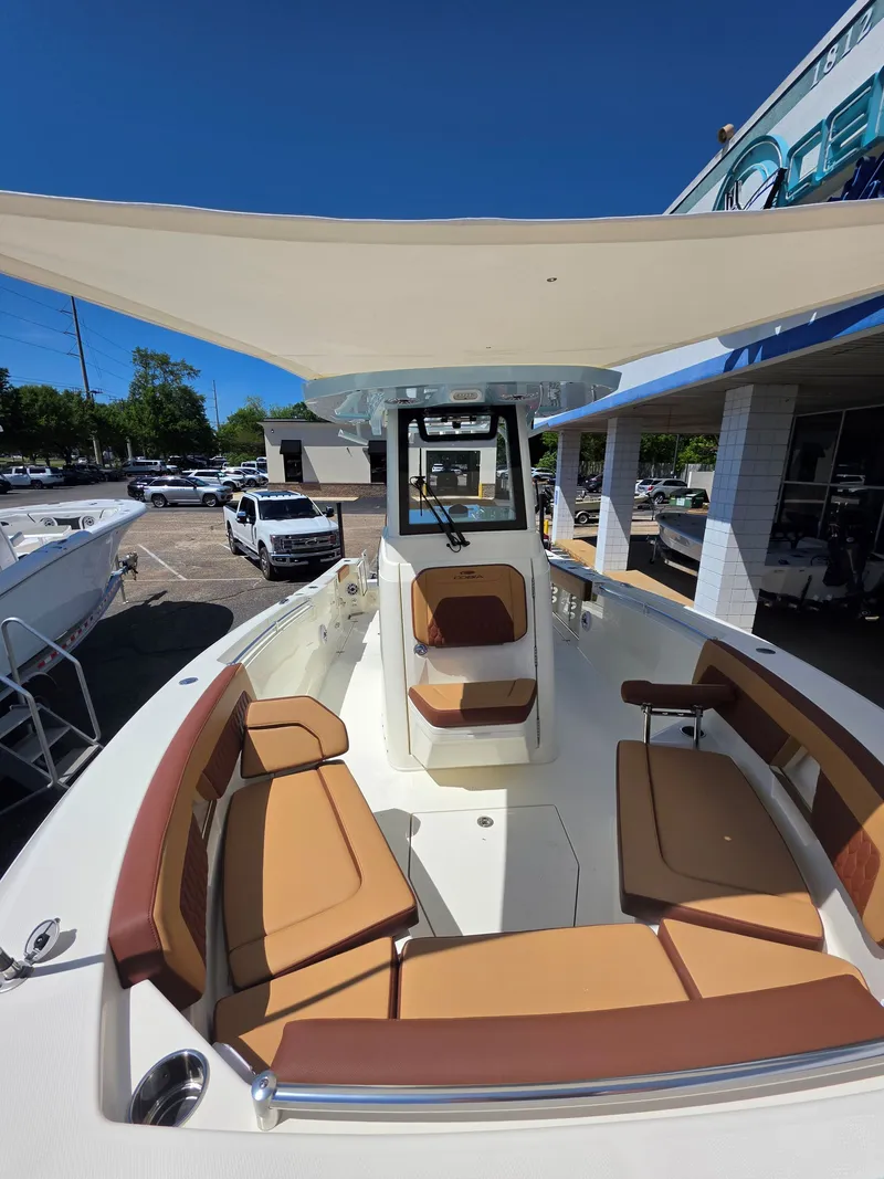 Slide: The Image of 2026 Cobia 245CC boat with beige interior and sunshade. - 23