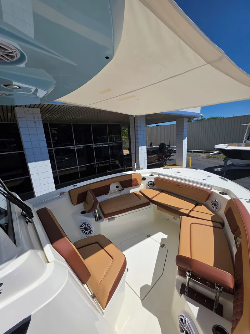 Slide: The Image of Interior view of 2026 Cobia 245CC with beige seating. - 24