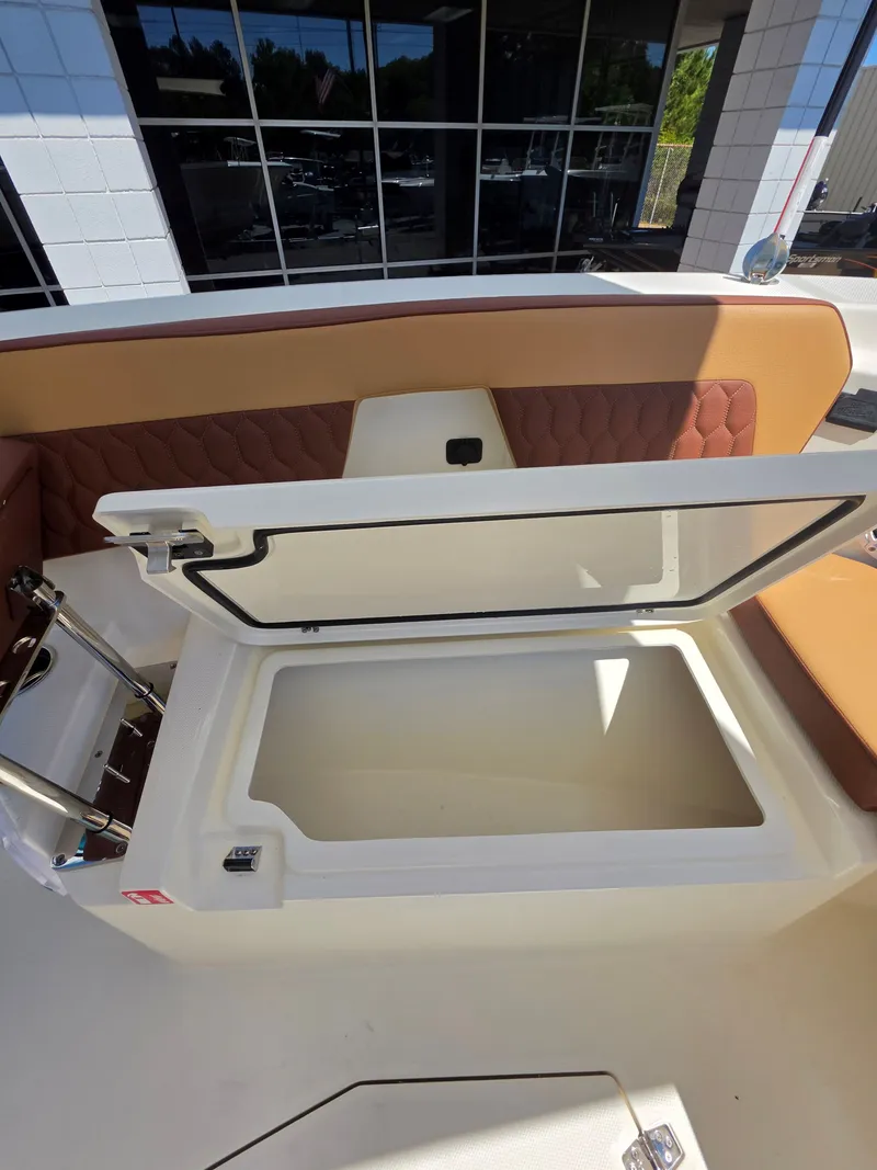 Slide: The Image of Open storage compartment on a 2026 Cobia 245CC boat. - 27
