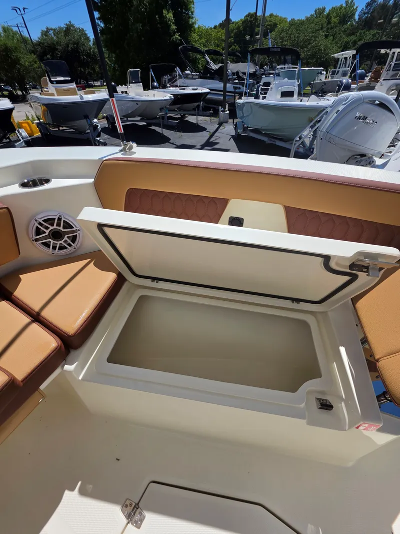 Slide: The Image of Open storage compartment on a 2026 Cobia 245CC boat. - 28