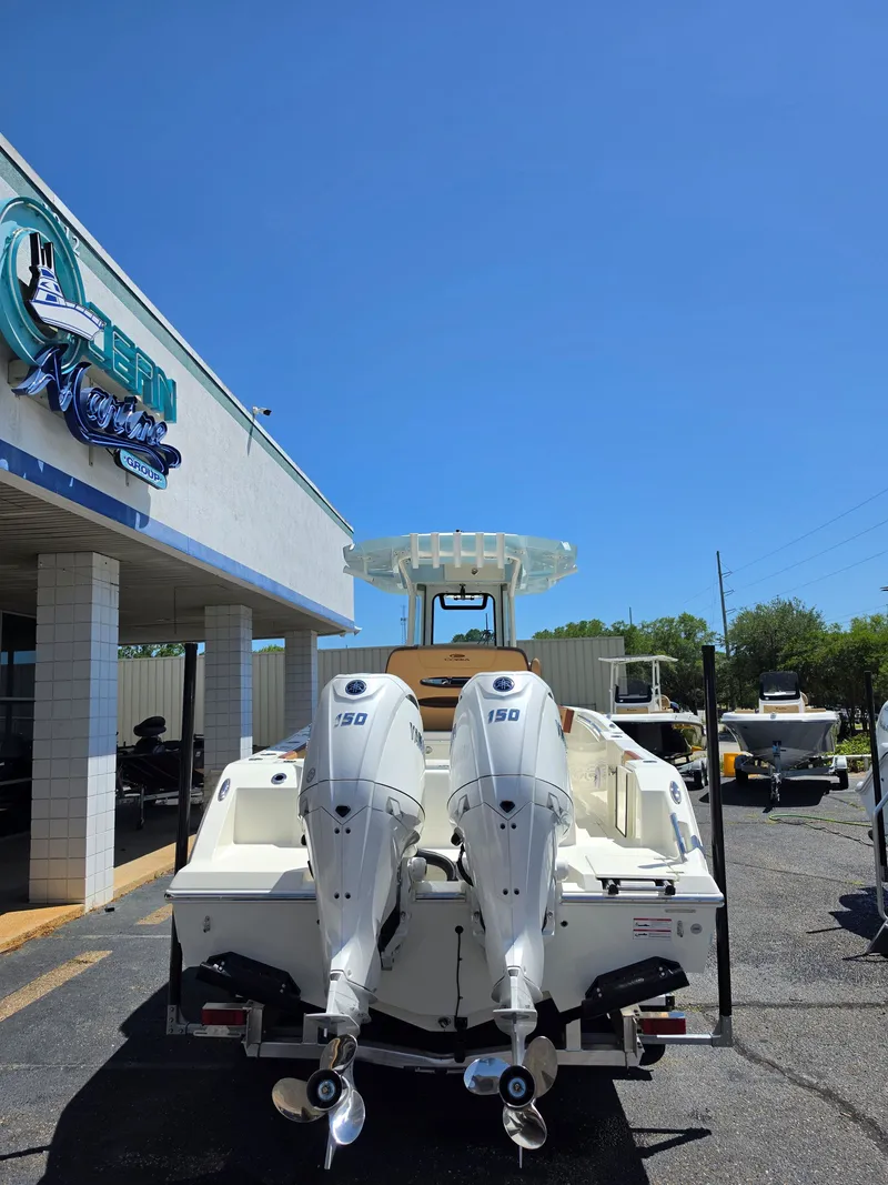 Slide: The Image of 2026 Cobia 245CC boat with dual outboard engines. - 3