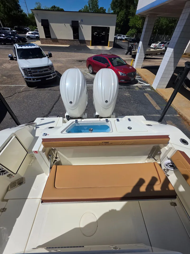 Slide: The Image of 2026 Cobia 245CC with dual outboard engines and seating area. - 8