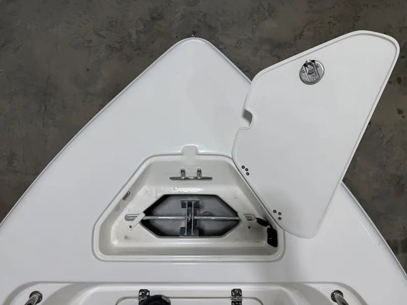 Slide: The Image of Key West 189 FS 2026 boat anchor compartment with open lid. - 26