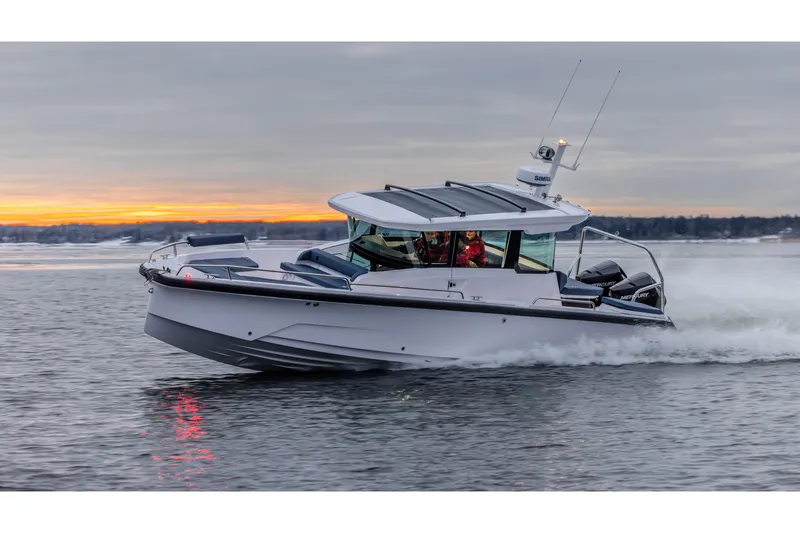 The Image of 2026 Axopar 29 XC Cross Cabin cruising at sunset on calm waters. - 0