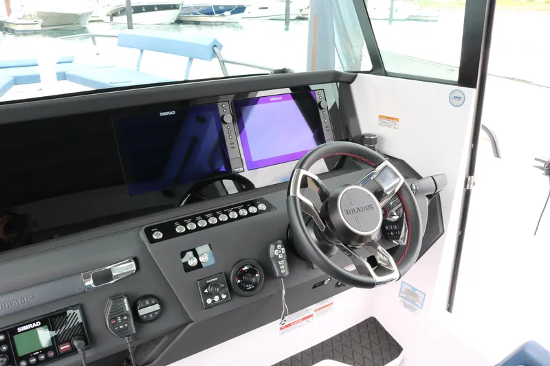 Slide: The Image of 2026 Axopar 29 XC Cross Cabin helm with advanced navigation displays and controls. - 37