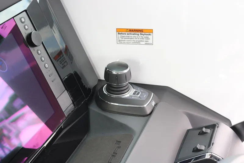 Slide: The Image of Control panel of 2026 Axopar 29 XC Cross Cabin with joystick and warning label. - 39