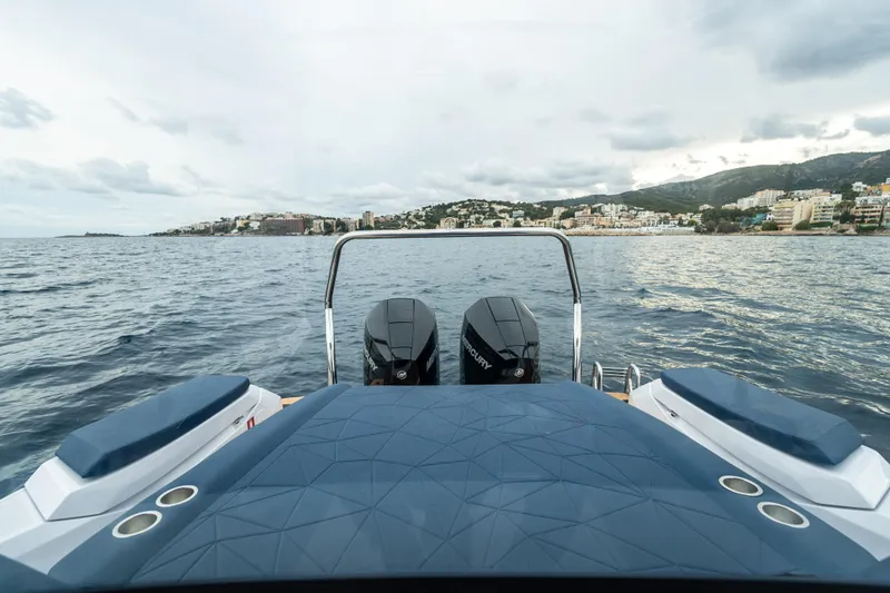 Slide: The Image of 2026 Axopar 29 XC Cross Cabin on water, cityscape in background. - 7