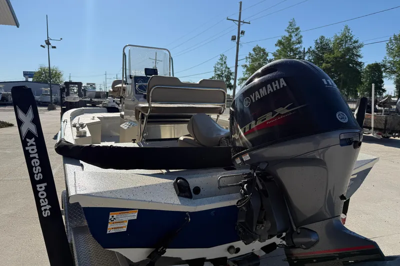 Slide: The Image of 2020 Xpress H20B Bay boat with Yamaha outboard motor, parked outdoors. - 5