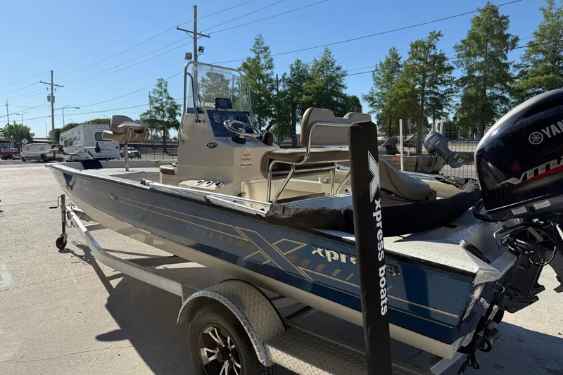 Slide: The Image of 2020 Xpress H20B Bay boat on trailer with Yamaha outboard motor, parked outdoors. - 6
