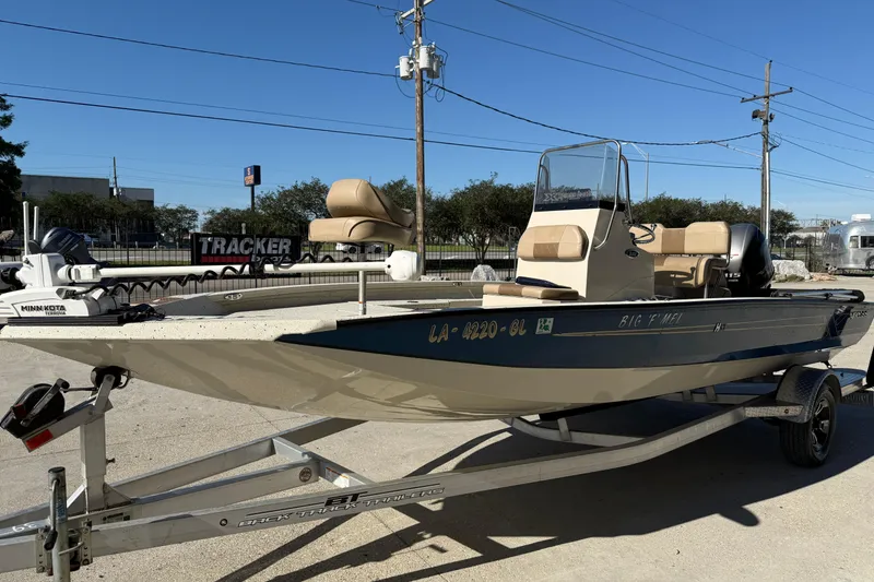 Slide: The Image of 2020 Xpress H20B Bay boat on trailer, parked outdoors under clear sky. - 8