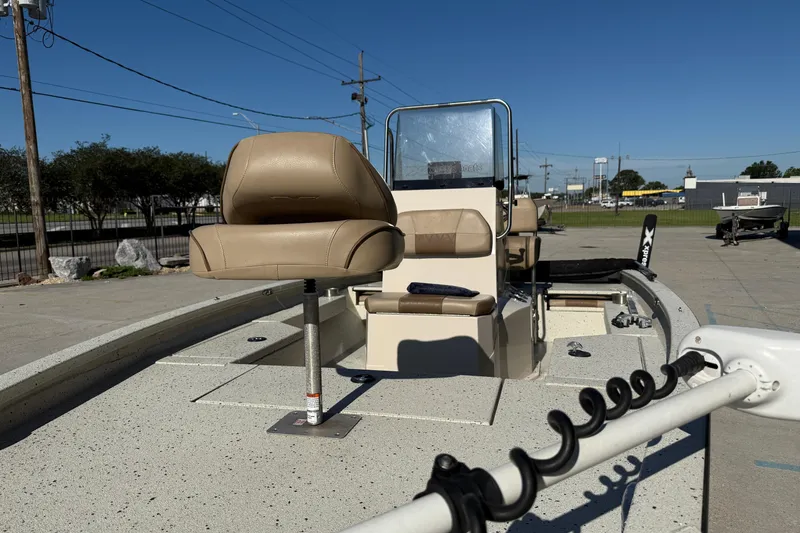 Slide: The Image of 2020 Xpress H20B Bay boat with tan seating and fishing rod holders. - 9
