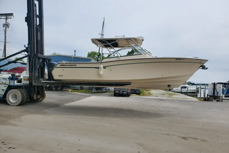The Image of 2011 Grady-White Freedom 307 boat lifted by forklift at marina. - 1