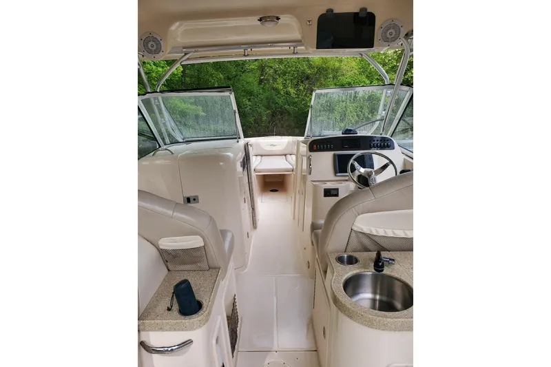 Slide: The Image of Interior view of 2011 Grady-White Freedom 307 boat, featuring helm and seating area. - 5