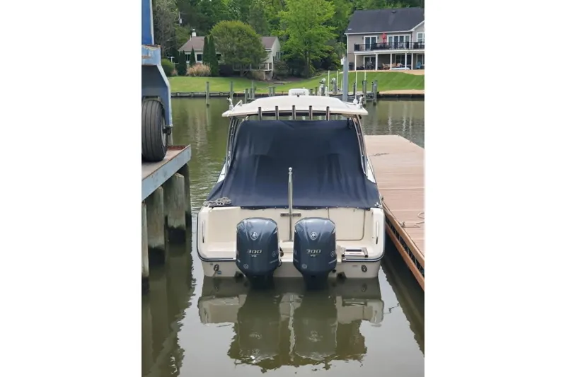Slide: The Image of 2011 Grady-White Freedom 307 boat docked with twin 300 HP engines. - 6