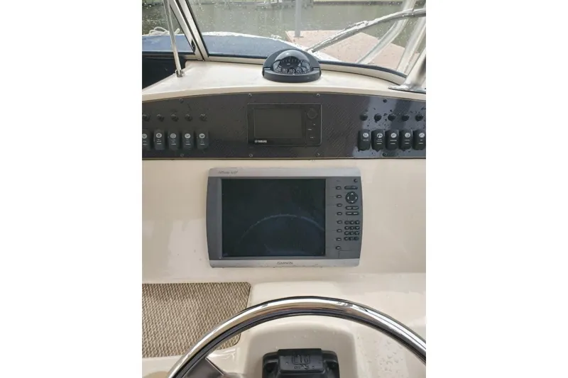 Slide: The Image of 2011 Grady-White Freedom 307 dashboard with Garmin navigation system and controls. - 7
