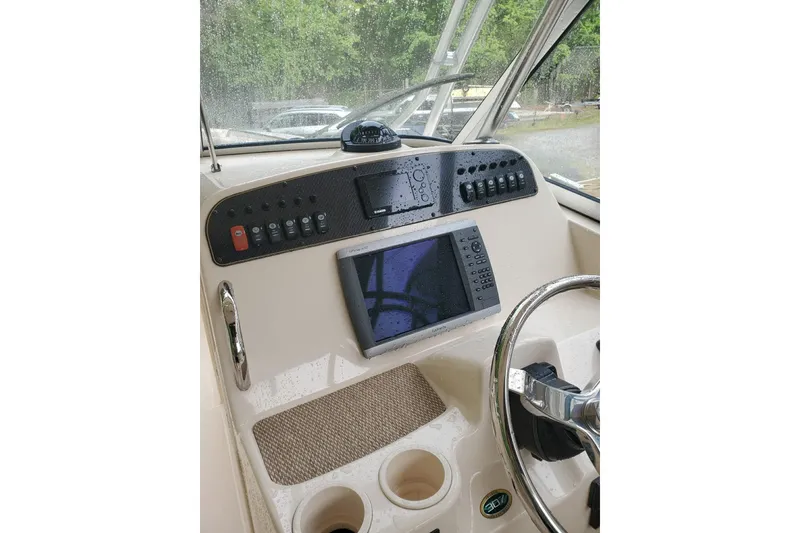 Slide: The Image of Grady-White Freedom 307 2011 boat dashboard with navigation controls and steering wheel. - 9