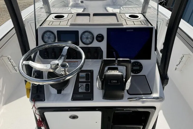 Slide: The Image of Control panel of 2020 Yamaha Boats 210 FSH Sport with steering wheel and navigation instruments. - 18