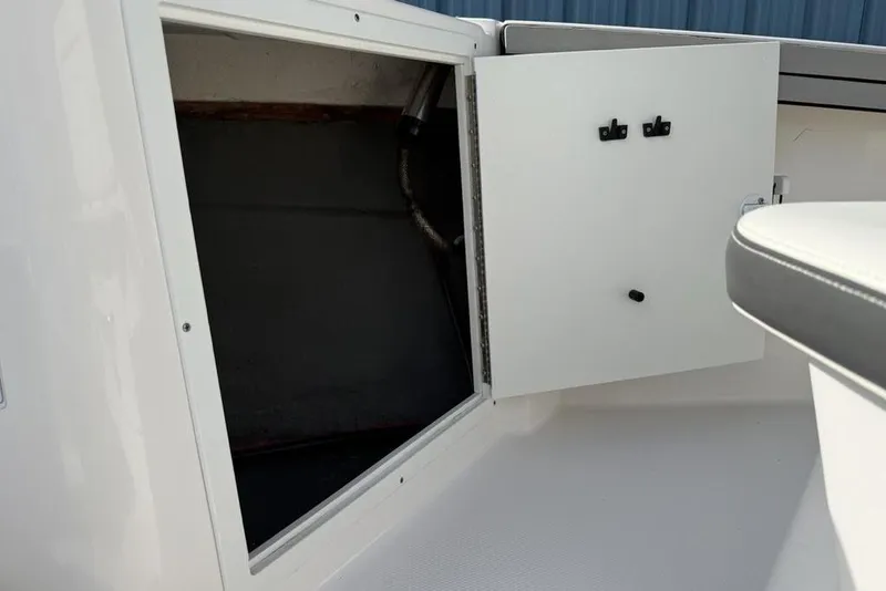 Slide: The Image of Open storage compartment on 2020 Yamaha Boats 210 FSH Sport, showcasing interior space. - 20