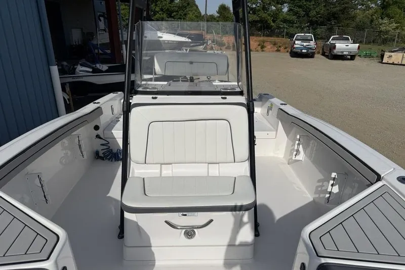 Slide: The Image of 2020 Yamaha Boats 210 FSH Sport interior, featuring spacious seating and sleek design. - 23