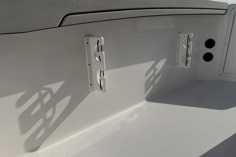 Slide: The Image of 2020 Yamaha Boats 210 FSH Sport interior with rod holders and sleek design. - 25