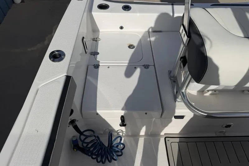 Slide: The Image of 2020 Yamaha Boats 210 FSH Sport interior with seating and storage compartments. - 27