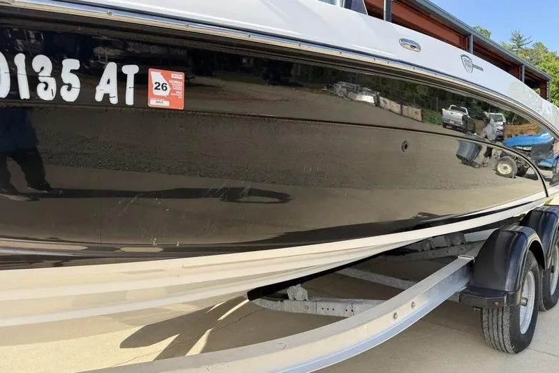 Slide: The Image of 2020 Yamaha Boats 210 FSH Sport on trailer, side view with registration details. - 3