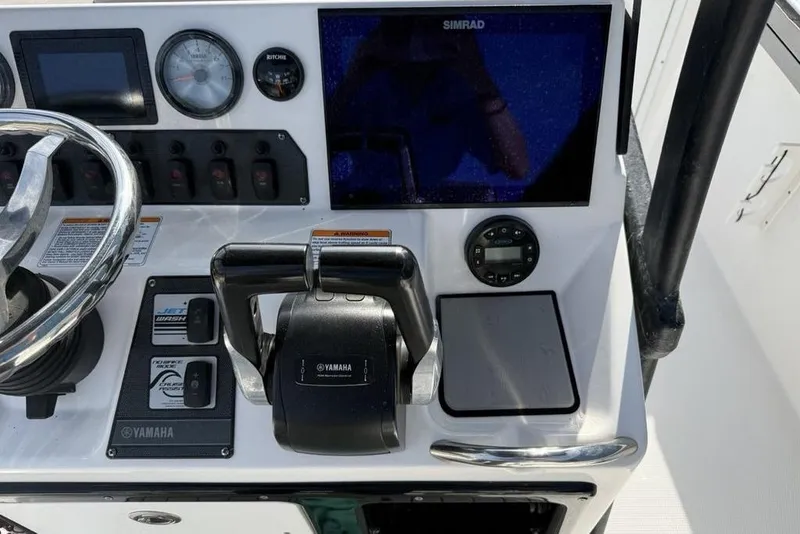 Slide: The Image of Control panel of 2020 Yamaha Boats 210 FSH Sport with steering wheel and navigation display. - 33